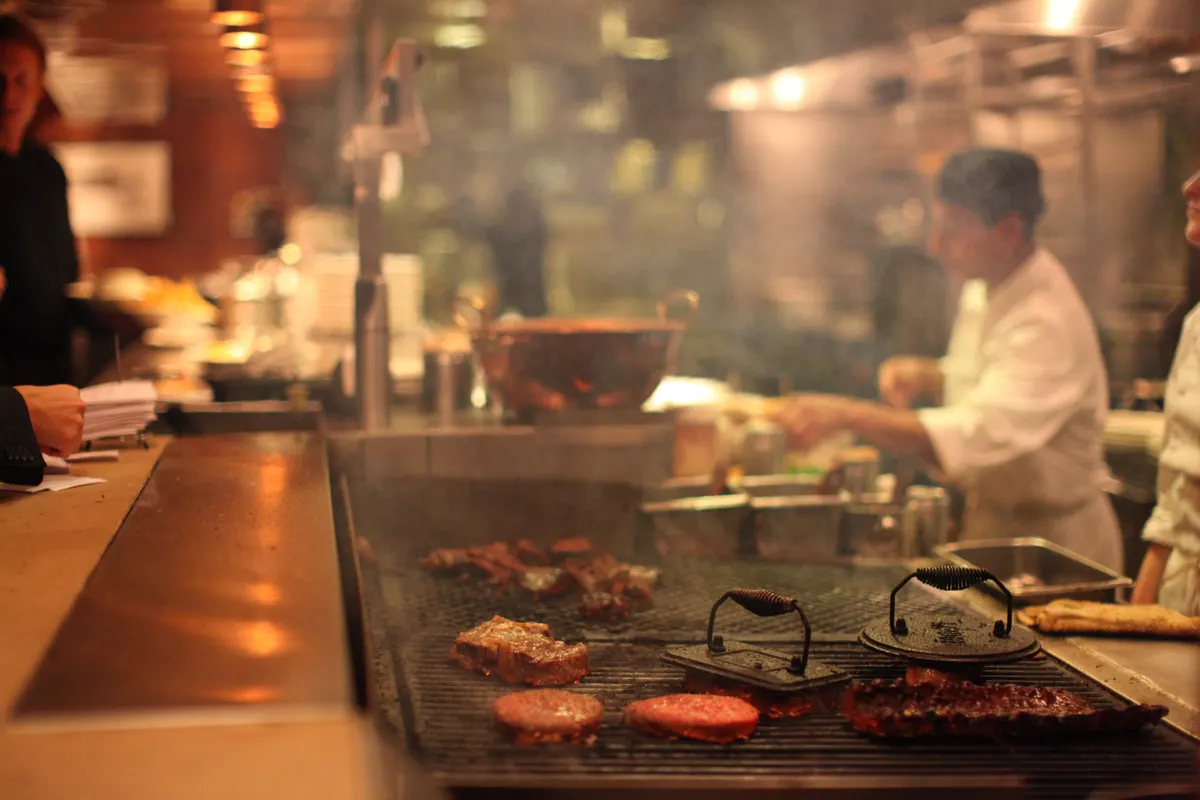 Busy restaurant grill line producing the fats oils and grease that load a trap